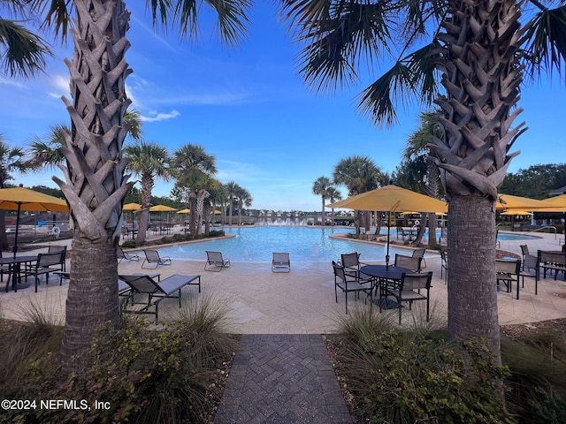 exterior space with a patio, a water view, and a community pool