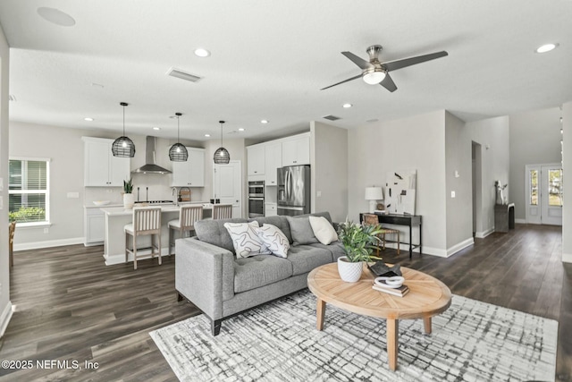 living room with dark wood-type flooring and ceiling fan