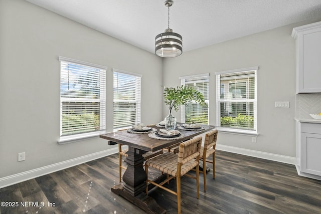 dining area with an inviting chandelier and dark hardwood / wood-style floors