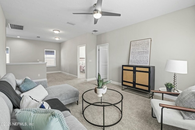 living room featuring ceiling fan and light colored carpet