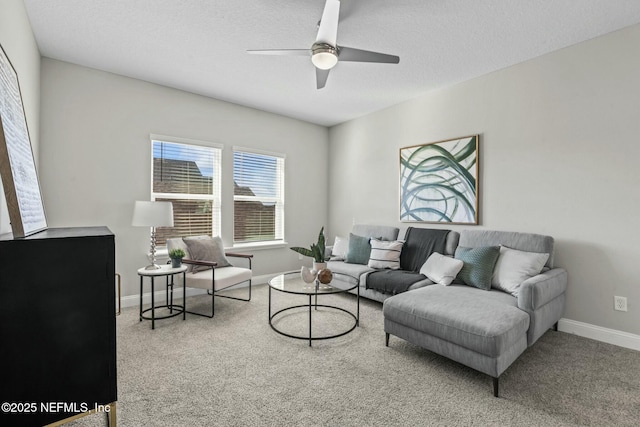 carpeted living room featuring a textured ceiling and ceiling fan