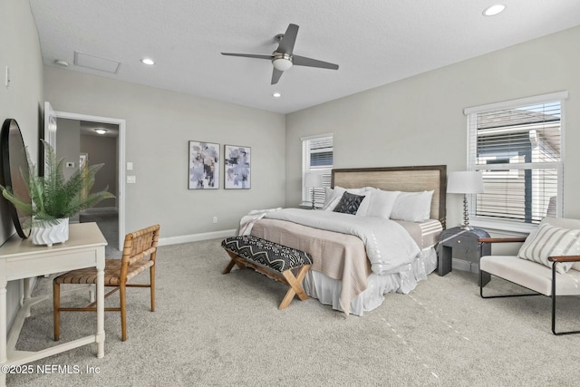 carpeted bedroom featuring a textured ceiling and ceiling fan