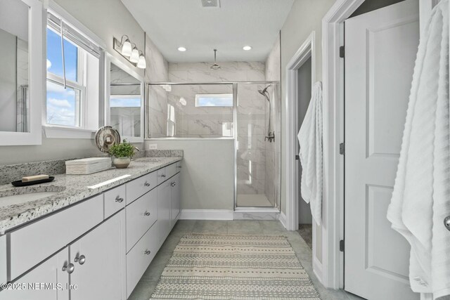 bathroom featuring vanity and an enclosed shower