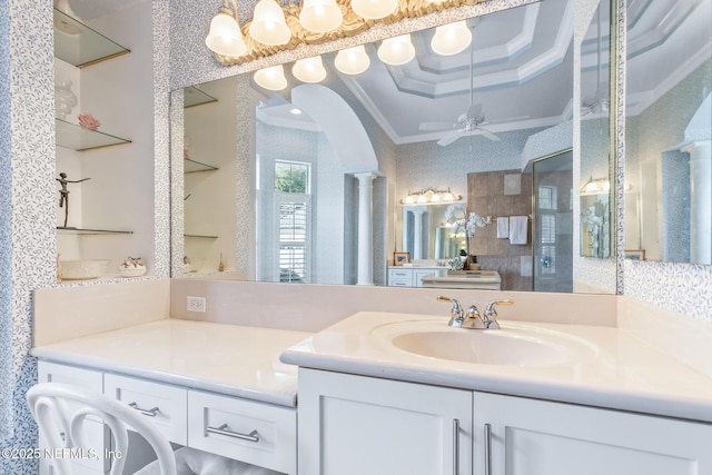 2095 Crown Dr, Saint Augustine, FL 32092 - bathroom featuring crown molding, ornate columns, ceiling fan, vanity, and a raised ceiling