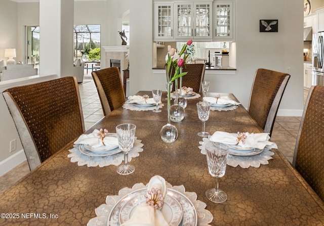 2095 Crown Dr, Saint Augustine, FL 32092 - dining area featuring baseboards, a fireplace, and tile patterned floors