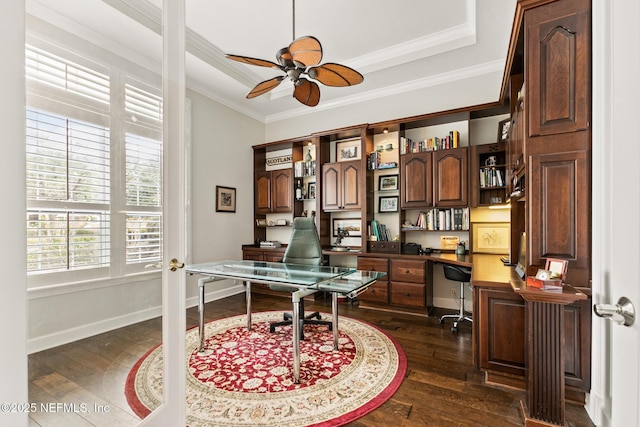 2095 Crown Dr, Saint Augustine, FL 32092 - home office featuring built in study area, crown molding, a tray ceiling, dark wood-style floors, and a ceiling fan