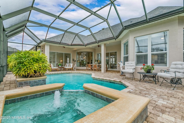 2095 Crown Dr, Saint Augustine, FL 32092 - view of swimming pool with glass enclosure, a pool with connected hot tub, a patio area, and a ceiling fan