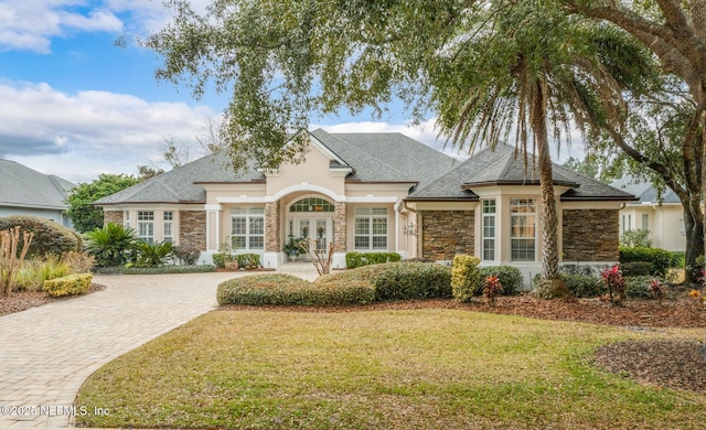 view of front of home with a front lawn and french doors