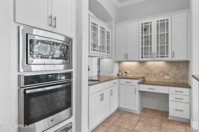 2095 Crown Dr, Saint Augustine, FL 32092 - kitchen featuring glass insert cabinets, dark stone counters, backsplash, and stainless steel appliances