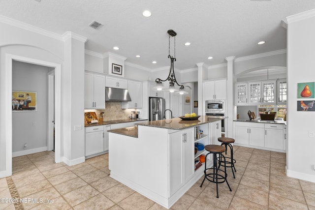 2095 Crown Dr, Saint Augustine, FL 32092 - kitchen with visible vents, stainless steel appliances, under cabinet range hood, white cabinetry, and backsplash