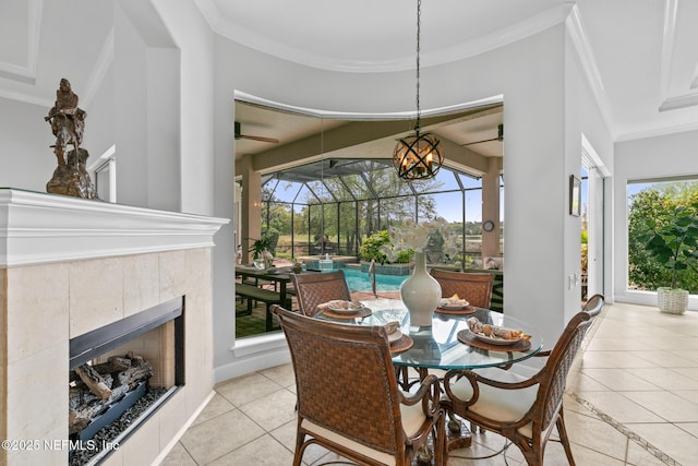 2095 Crown Dr, Saint Augustine, FL 32092 - dining room with a tiled fireplace, light tile patterned floors, ornamental molding, and baseboards