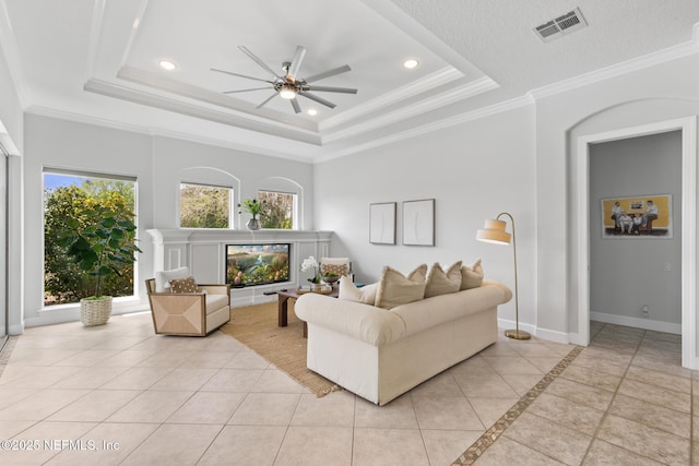 2095 Crown Dr, Saint Augustine, FL 32092 - living area featuring a wealth of natural light, a ceiling fan, a raised ceiling, baseboards, and visible vents