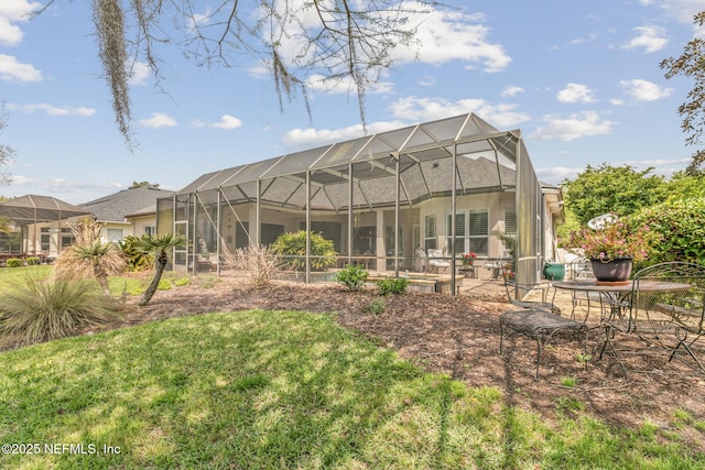 2095 Crown Dr, Saint Augustine, FL 32092 - back of property with stucco siding, a patio area, a lawn, and glass enclosure