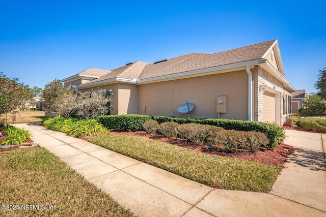 view of home's exterior featuring a garage and a lawn