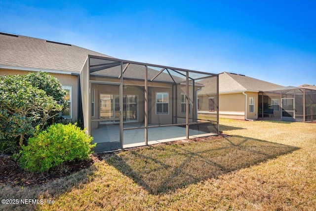 rear view of house with a yard, a lanai, and a patio area