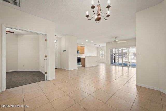 unfurnished living room featuring ceiling fan with notable chandelier, a textured ceiling, and light tile patterned floors