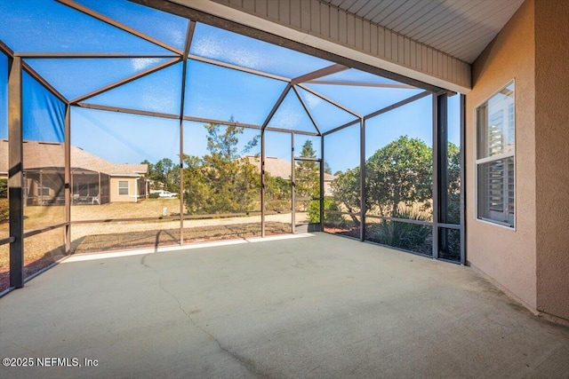 view of patio with glass enclosure