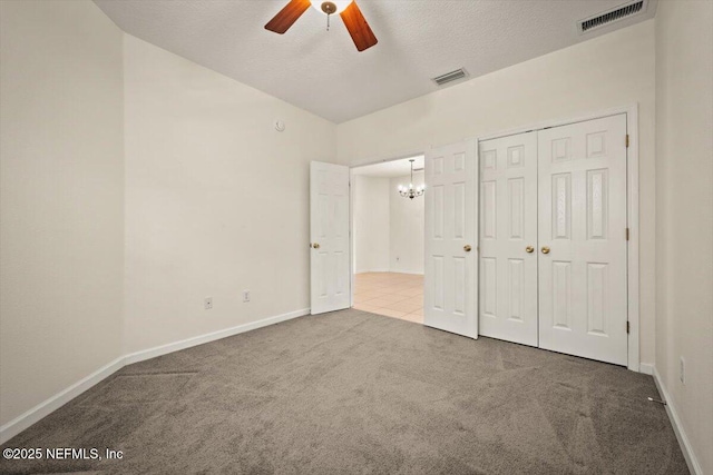 unfurnished bedroom with ceiling fan, a closet, carpet, and a textured ceiling