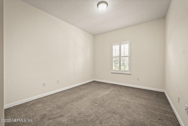 carpeted spare room featuring a textured ceiling