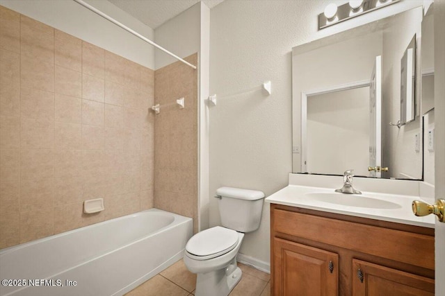 full bathroom with tiled shower / bath, vanity, tile patterned floors, and toilet