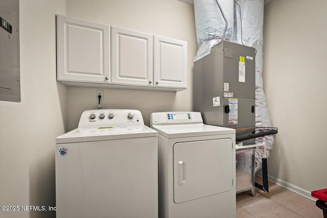 clothes washing area with cabinets, electric panel, separate washer and dryer, and light tile patterned floors