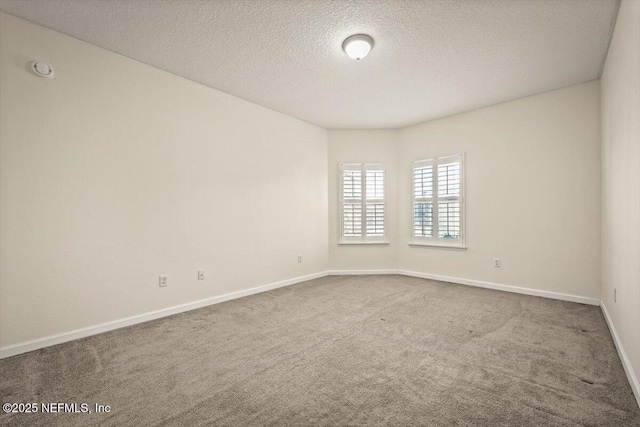 empty room featuring carpet flooring and a textured ceiling