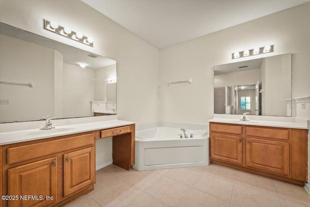 bathroom featuring a tub to relax in, tile patterned flooring, and vanity