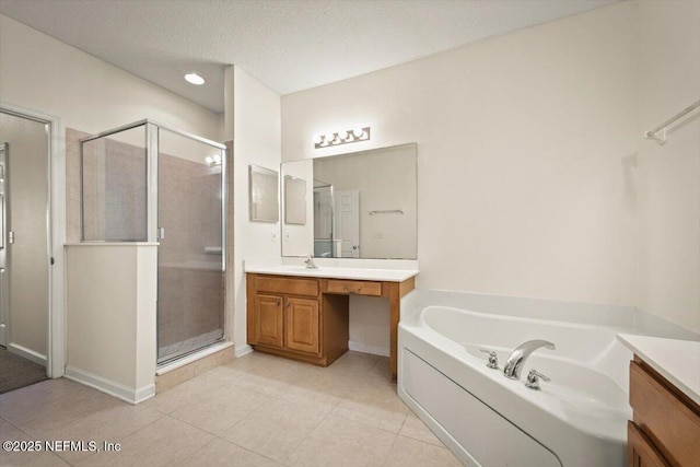 bathroom featuring vanity, tile patterned flooring, independent shower and bath, and a textured ceiling