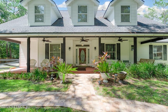 view of front of property featuring covered porch, roof with shingles, and ceiling fan