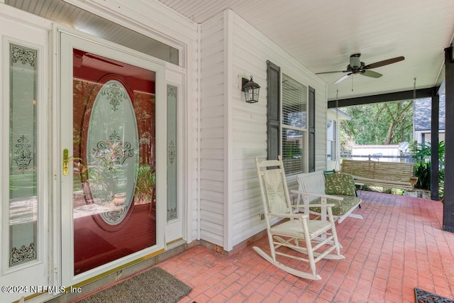 property entrance featuring a ceiling fan and covered porch