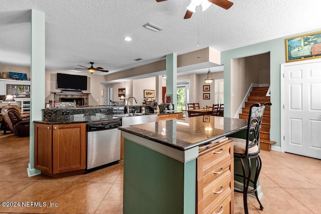 kitchen with a center island, visible vents, open floor plan, dishwasher, and a peninsula