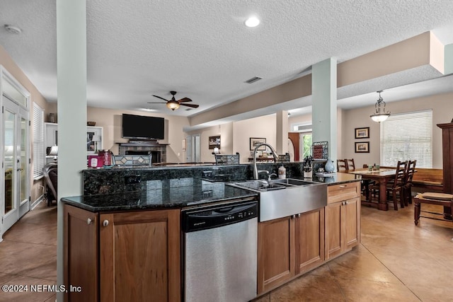 kitchen featuring light tile patterned floors, stainless steel dishwasher, a ceiling fan, open floor plan, and a sink