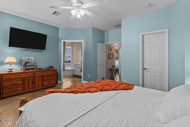 bedroom featuring a ceiling fan, connected bathroom, visible vents, and a textured ceiling