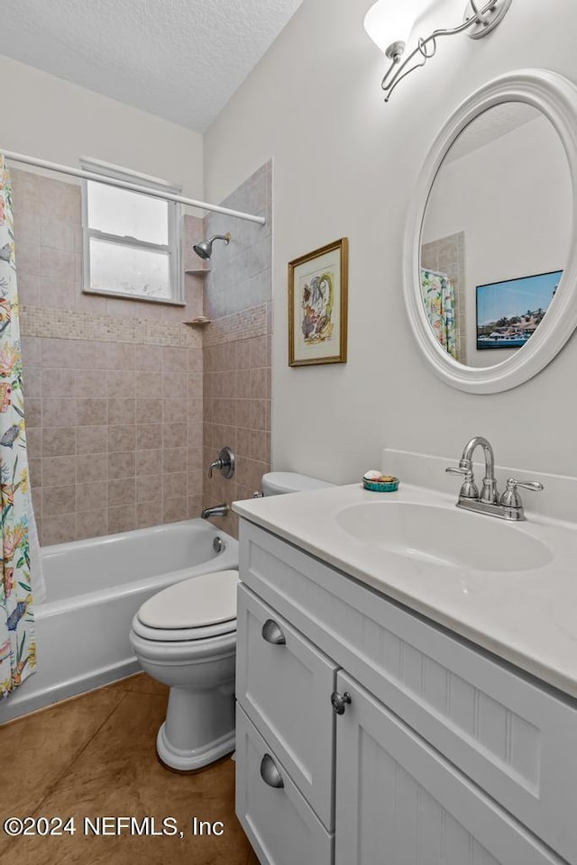 full bathroom featuring toilet, tile patterned flooring, shower / bath combo with shower curtain, a textured ceiling, and vanity