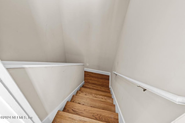 stairs with baseboards and wood finished floors