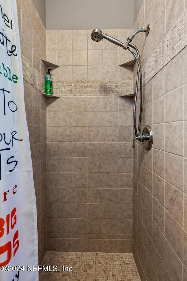 bathroom featuring a shower stall