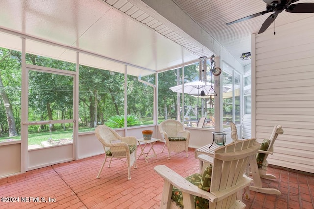 sunroom / solarium featuring ceiling fan