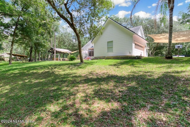 view of side of property featuring a yard and an attached garage