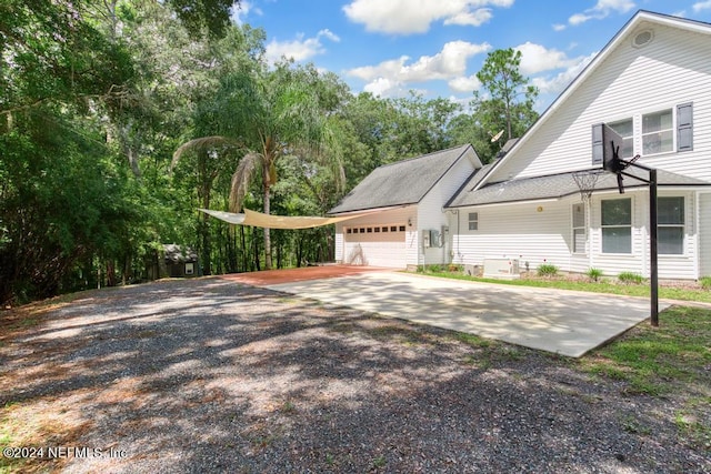 view of home's exterior featuring an attached garage and concrete driveway