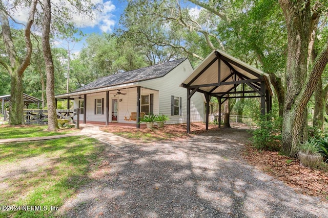 view of front of property featuring a ceiling fan and a porch