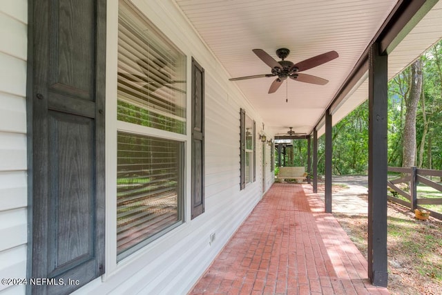 view of patio with ceiling fan and a porch