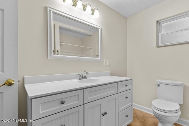 bathroom featuring baseboards, toilet, tile patterned flooring, a textured ceiling, and vanity