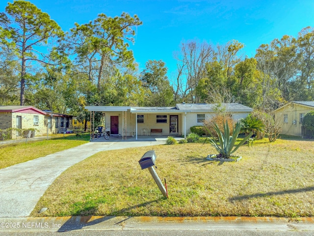 ranch-style house featuring a carport and a front lawn