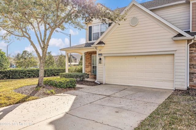 view of front of house with a garage and a front lawn