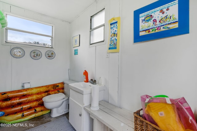 bathroom featuring sink, plenty of natural light, and toilet