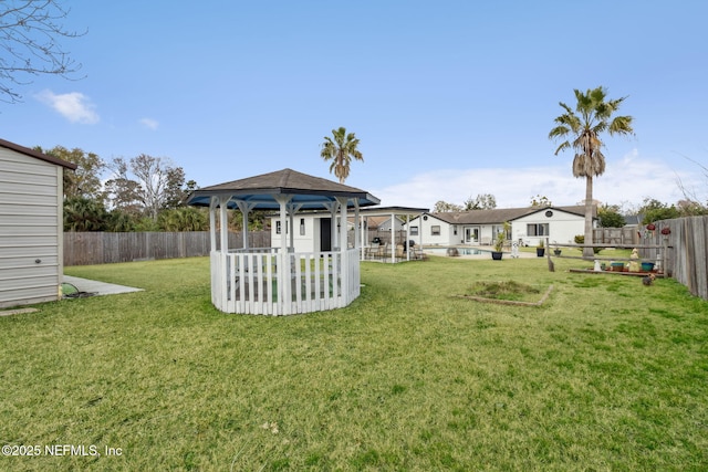 view of yard with a fenced in pool and a gazebo