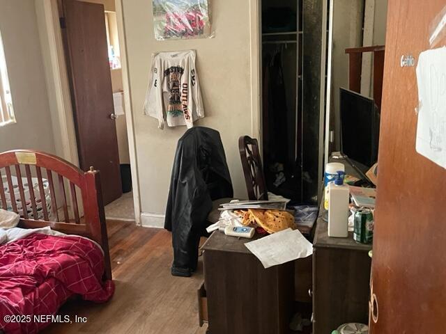 bedroom featuring hardwood / wood-style flooring and a closet