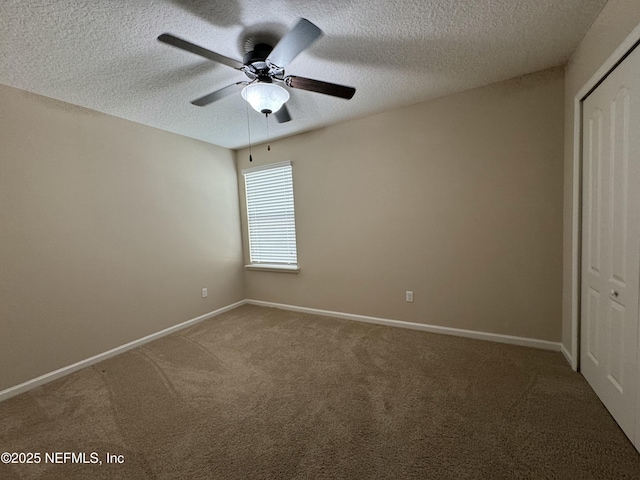 unfurnished bedroom with ceiling fan, carpet floors, a textured ceiling, and a closet