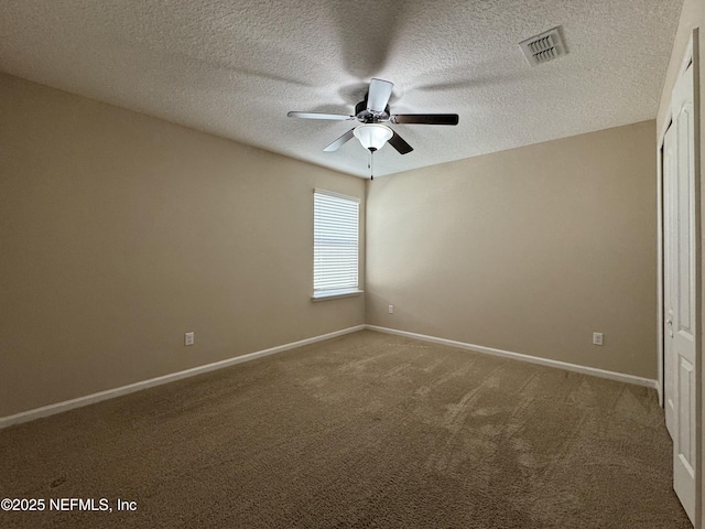 empty room with a textured ceiling, carpet floors, and ceiling fan