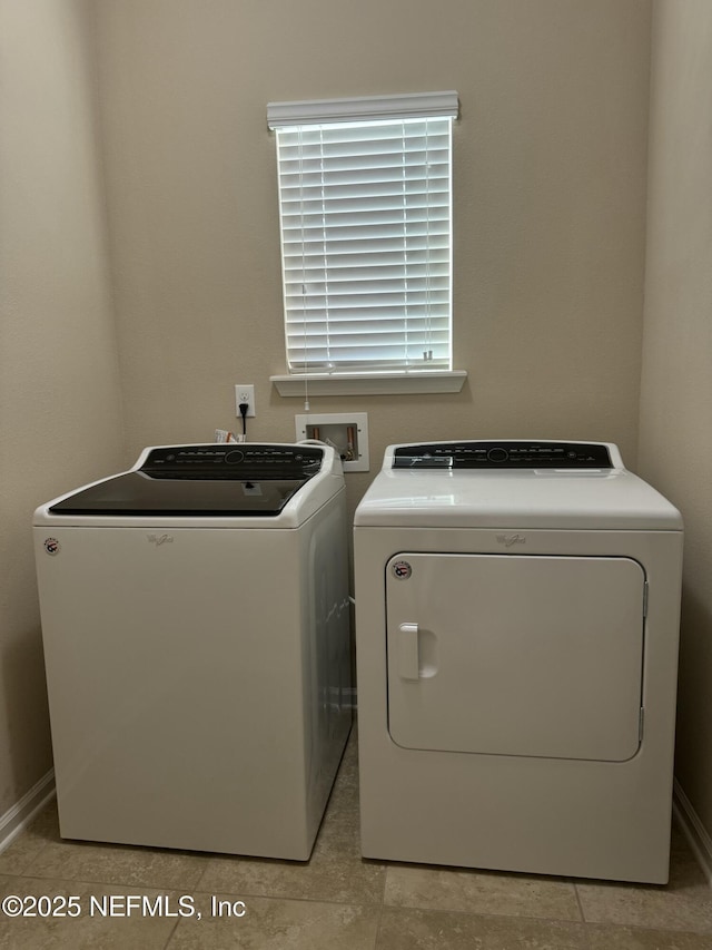 clothes washing area featuring separate washer and dryer